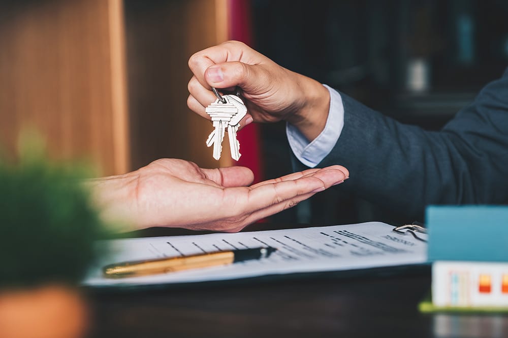 man handing over keys to new place
