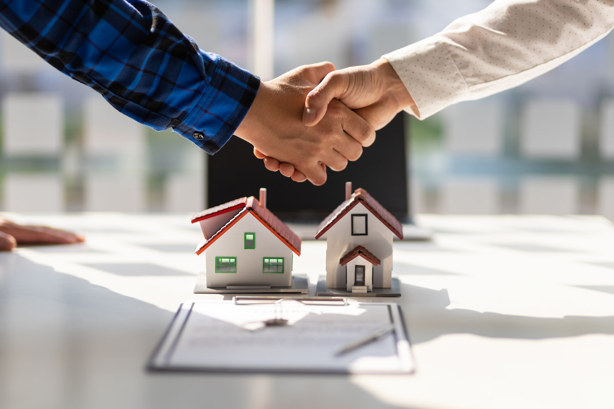 shaking hands over investment property